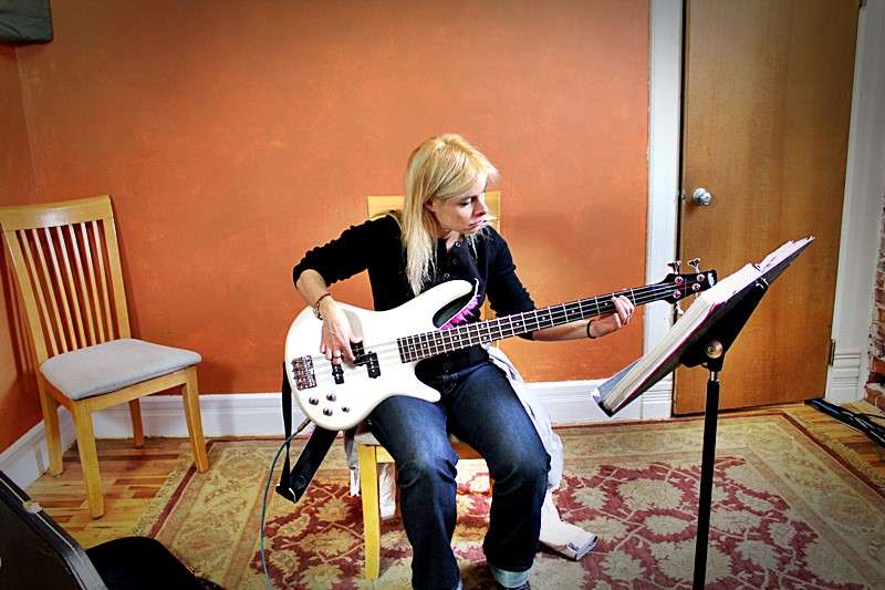 A student, Tami, playing the bass.