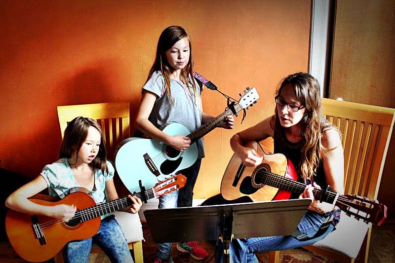 A family guitar lesson.